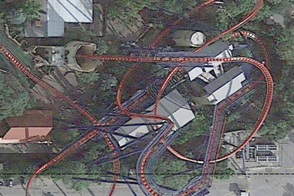 Aerial view of an amusement park roller coaster and midway served by distributed wireless coverage